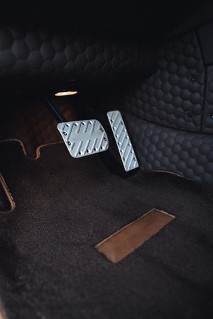 Close view of car pedals showing modern design and sleek materials in a stylish interiorの写真素材