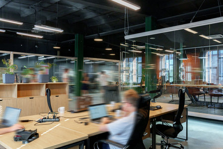 Modern office space with employees working in a collaborative environment during daytime hours