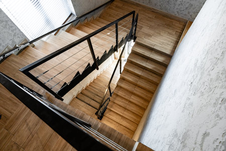 Staircase view showing wooden steps and metal railing in modern interior design