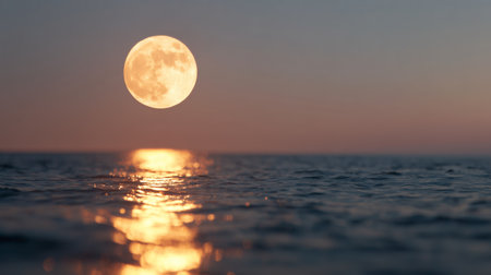 Moonrise over calm ocean waters during twilight reflecting light on the surfaceの素材
