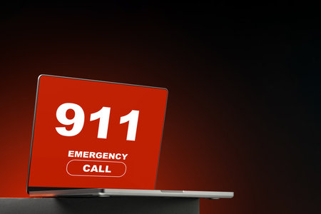Emergency 911 call displayed on a laptop screen in a dark settingの写真素材