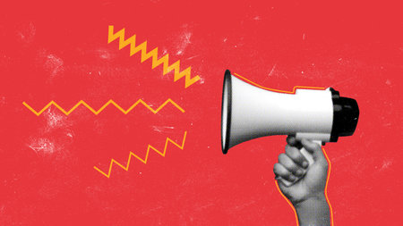 Hand holding a megaphone delivering a message in a vibrant settingの写真素材