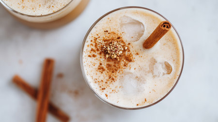 Delicious creamy beverage with cinnamon and ice in a clear glassの素材