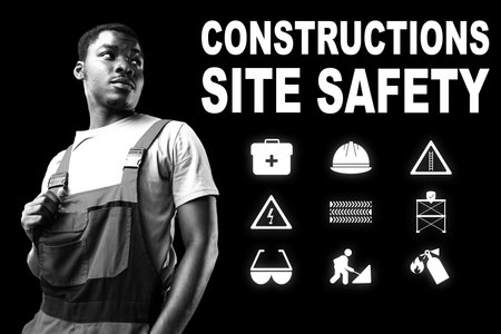 Construction worker emphasizes site safety with key symbols in a bold displayの写真素材