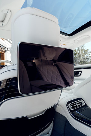 High-tech entertainment screen in luxury vehicle interior during daytime
