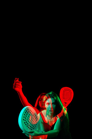 Woman practicing in dramatic lighting with colorful effectsの写真素材