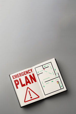 Emergency plan document with a detailed map for safety procedures in a buildingの写真素材