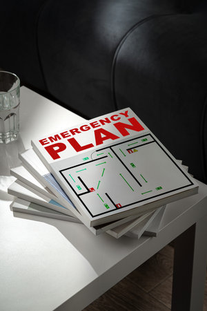 Emergency plan manuals stacked on a table, ready for quick access in case of emergenciesの写真素材