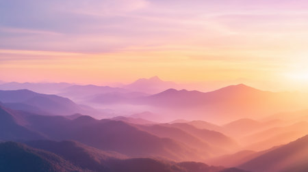 Sunrise over mountains with soft light illuminating the valleys and peaks in the early morningの素材