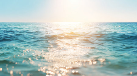 Waves move gently under the sun at the ocean in the early morning lightの素材