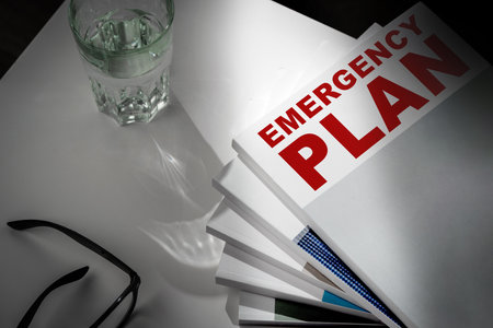 Emergency plan documents with glasses and glass of water on a tableの写真素材
