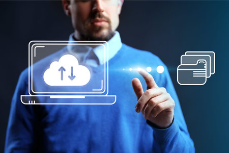 Man using technology to manage cloud services and data transfer on a laptop screen