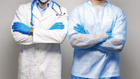 Health workers wear medical gear and stand together in a clinical setting during the dayの写真素材