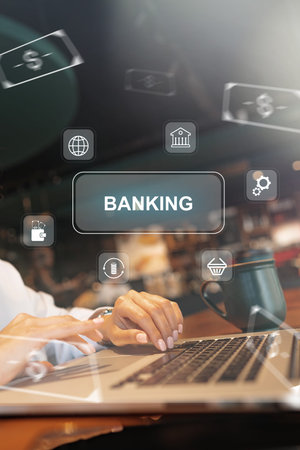 User making banking payments on a laptop with icons in background at a coffee shopの写真素材
