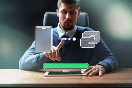 Man interacts with digital display for mobile payment process in office setting during daylight