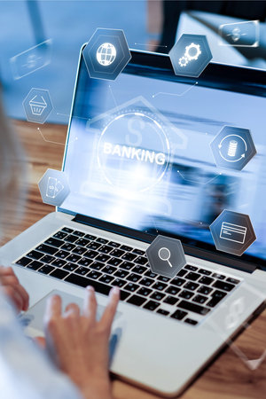 Processing payment for banking invoice on a laptop at a workspace during the dayの写真素材