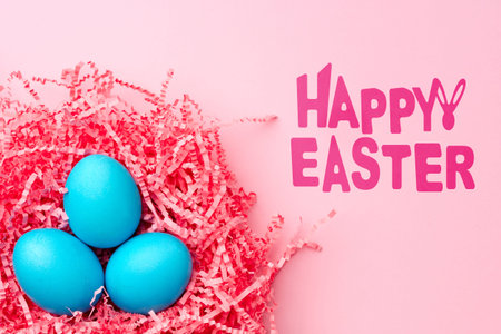 Colorful blue eggs in pink straw celebrate Easter holiday festivities and joy