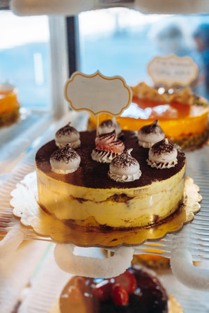 Sweet dessert display with layered cake and cream toppings in a bakery setting