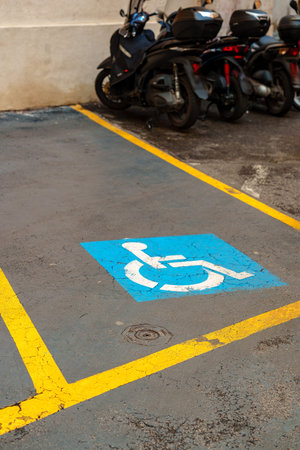Parking space for people with disabilities near motorcycles in a city area