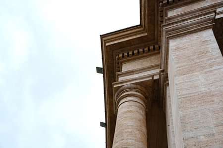 Large columns reach toward the sky on a historic building during an overcast day