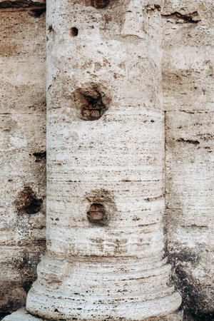 Old stone column shows wear and tear in a historic location on a sunny day