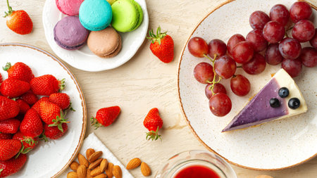 Fruit, sweets, and dessert on plates at a table during a casual gathering