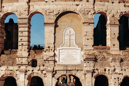 Historic Roman architecture shows the Colosseum in sunlight with visitors exploring