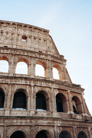 Colosseum in Rome shows ancient architecture under clear sky during daylight hours