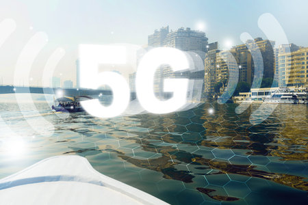 5G internet signal seen by boat on water near city buildings during daytime