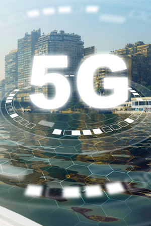 5G internet connections reflect in the waters of a busy cityscape by the riverの写真素材