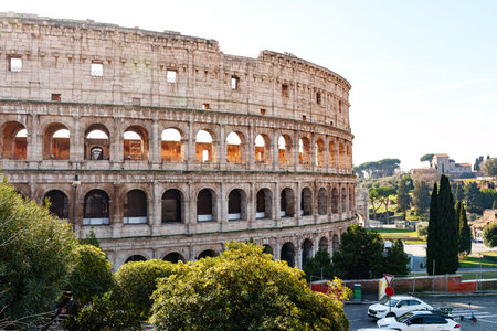 Exploring the colosseum in rome during a sunny afternoon with clear blue skies