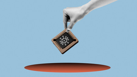 Hand holding a computer chip above a hole in a blue background