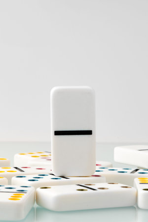 White domino stands out among scattered pieces during a game session at home