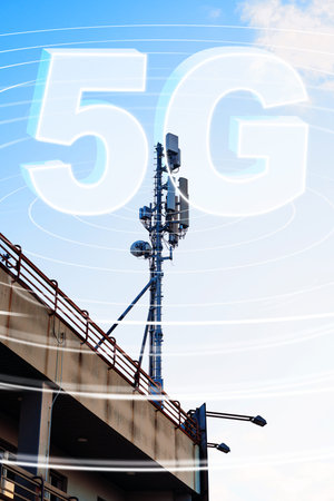 5G network tower with signal waves above a building during daylight hours