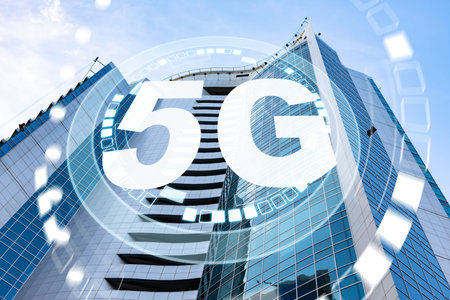 Modern building in city with 5G technology symbol and clear blue sky in background