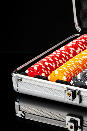 Poker chips are organized in a case ready for a game night with friends
