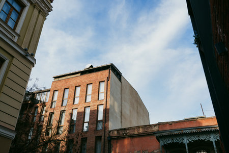 Buildings under blue sky with clouds in city during day