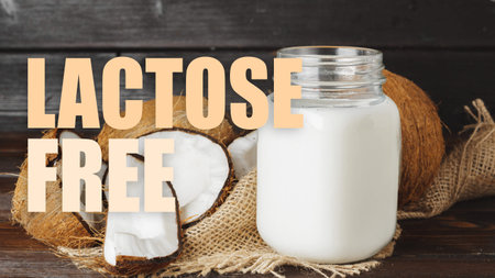 Coconut milk in jar with coconut pieces on wooden table labeled as lactose free