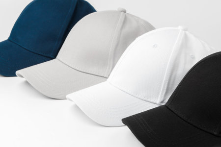 Various caps arranged in a line showing different colors and styles for casual wear