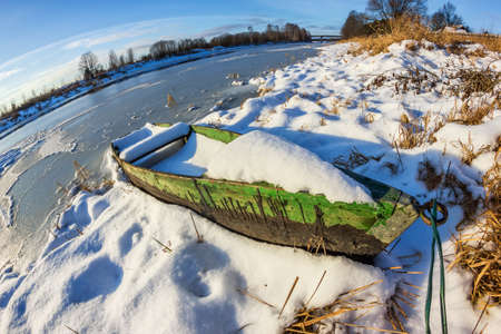 Waiting for Spring. Boat on the river.の写真素材