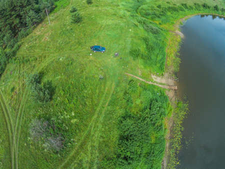 The view from the height of the river Mologa and the car next to the river bank.の写真素材