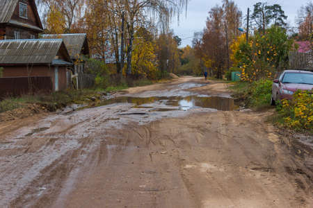 The road to the village is very poorly repaired, the pits appear constantly.の写真素材