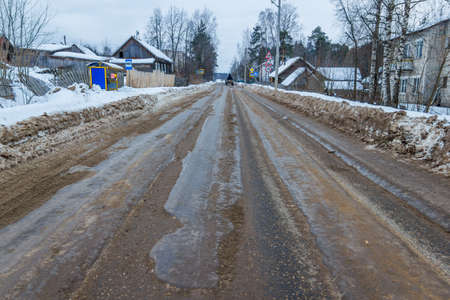 Bad road is not cleared in time. Municipal service time has not removed the snow and got this bad and dangerous road.の写真素材