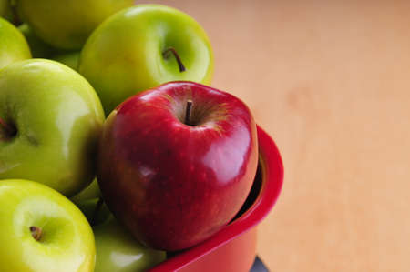 Close-up of a red apple amidst green onesの写真素材