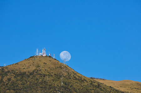 Full moon hiding behind the Quito cable carの写真素材