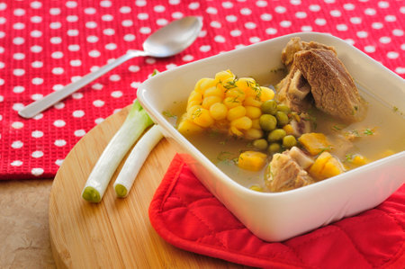 Sancocho is a traditional Ecuadorian dish, full of flavor and tradition. This comforting soup combines tender meat, corn, potatoes and peas in a flavorful broth, accompanied by fresh herbs that enhance its aroma.の写真素材