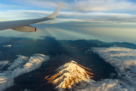 Stunning aerial view of the majestic Chimborazo volcano, the closest point to the sun on Earth, captured at dawn from the window of a commercial flight at 30,000 feet.の写真素材