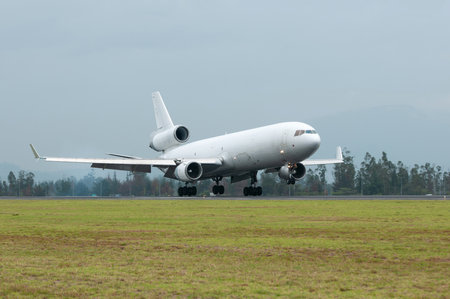 An all-white cargo plane touching down.の写真素材