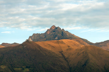 Stunning view of Ruco Pichincha and the Quito Cable Car station in Cruz Loma, captured during a serene Andean morning from El Auqui Hill.の写真素材