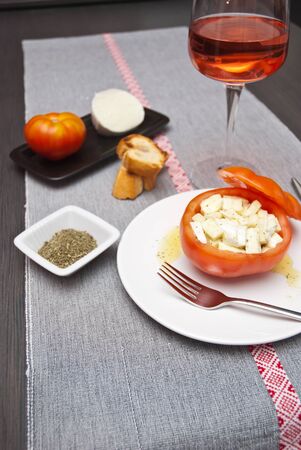 Tomatoes stuffed with buffalo mozzarella cheese with spicesの写真素材